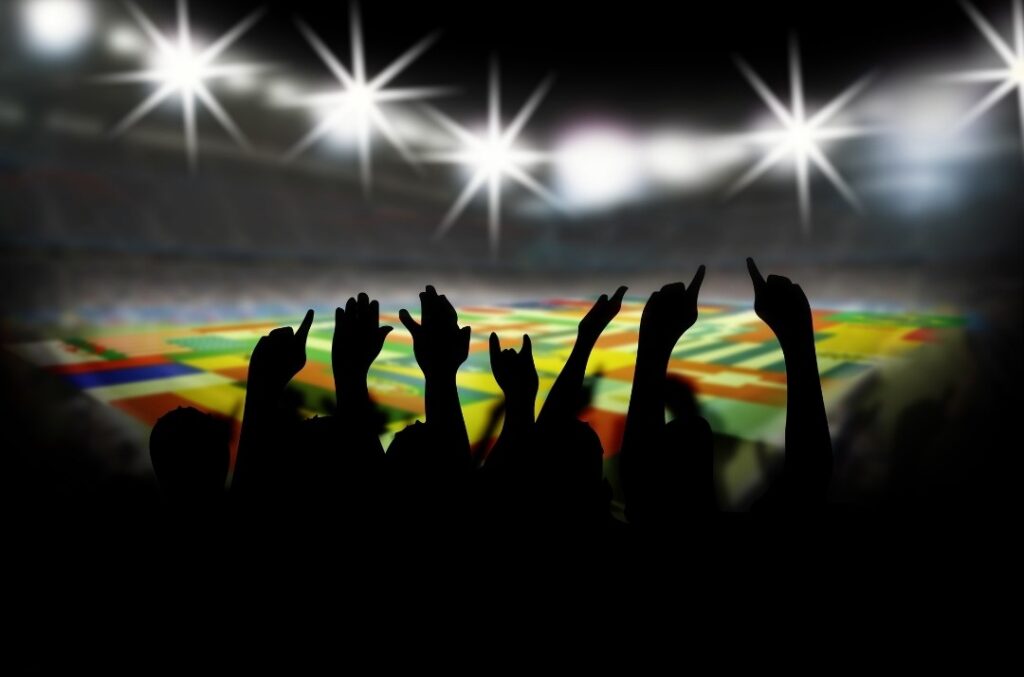 Soccer fans cheering at a FIFA World Cup game.