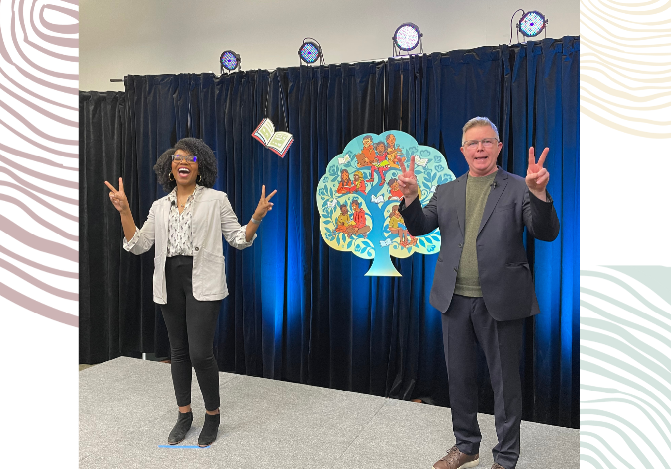Two people on stage during a presentation